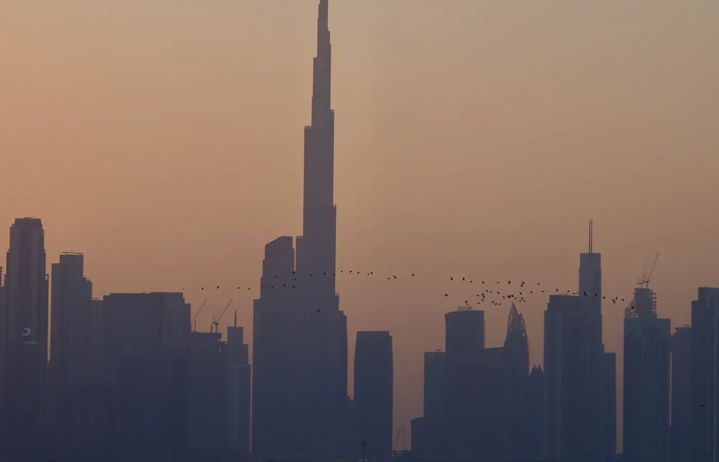 Dubai skyline at sunset seen across the waterfront