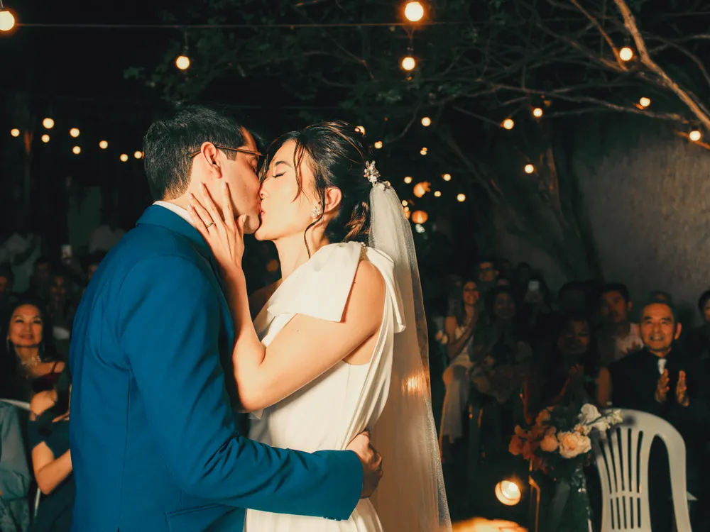 Couple together under evening lights after their wedding
