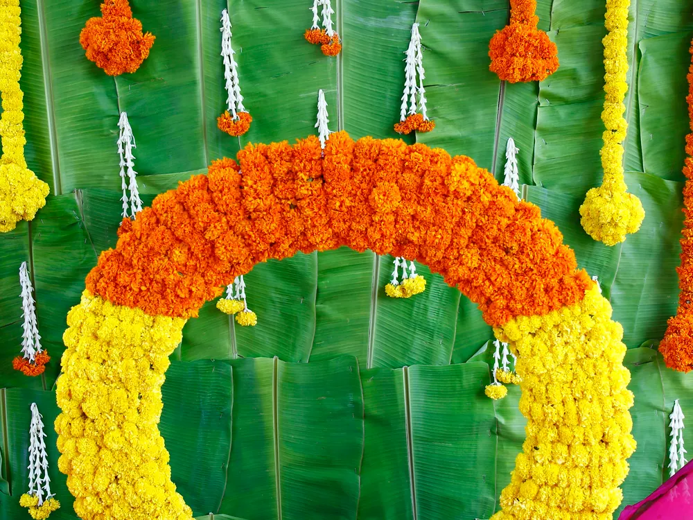 Statement wedding floral arrangement with tropical leaves