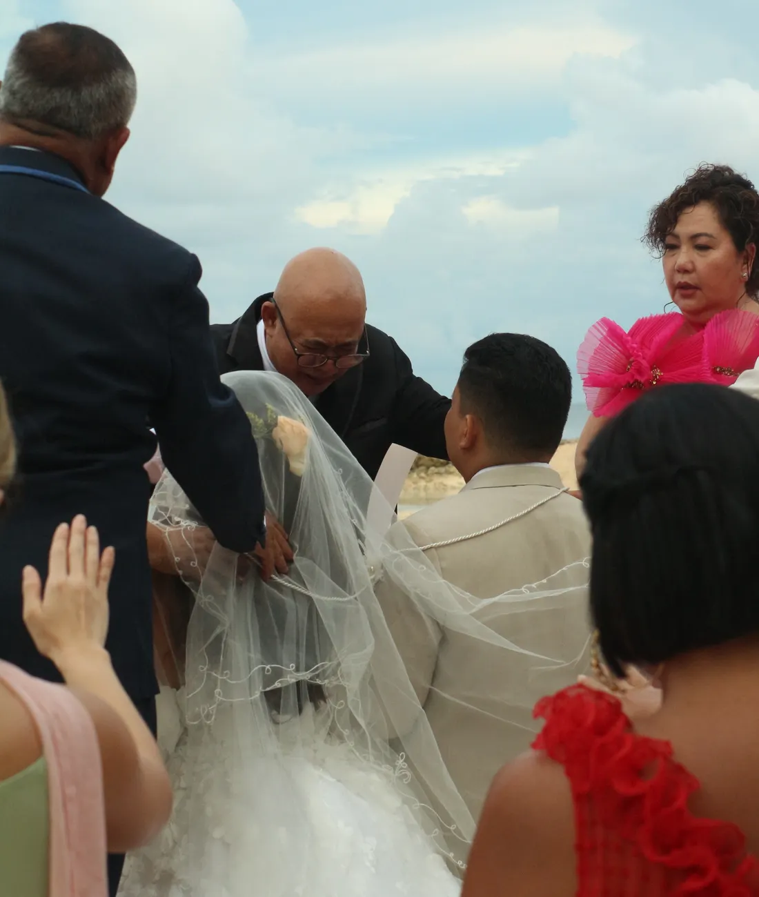 Grand formal wedding ceremony with guests seated around the couple