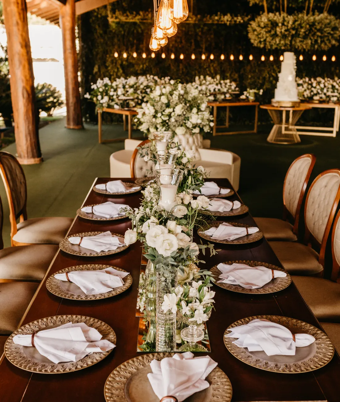Indian wedding table dressed with floral arrangements and warm lighting